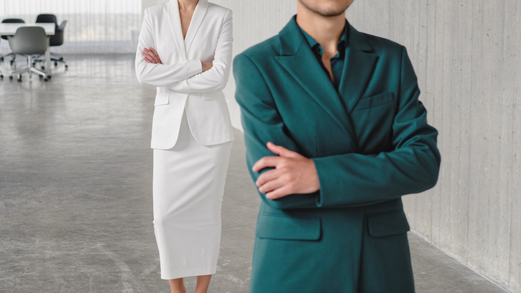 Two professionals in a composed, formal stance conveying oversight and integrity