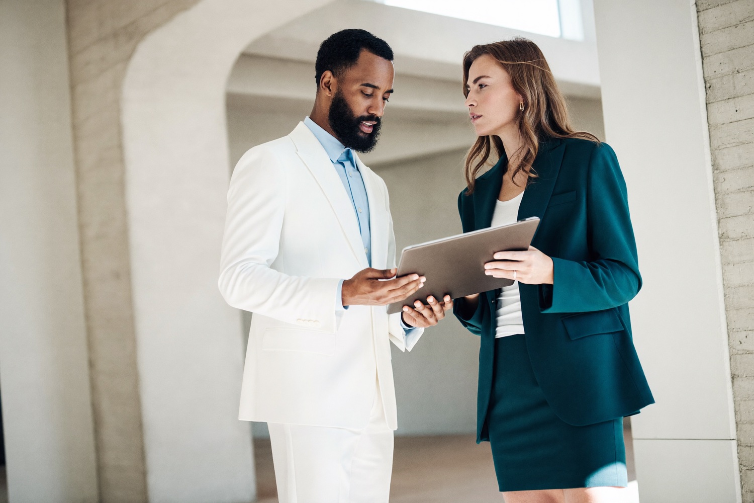 Two professionals reviewing work together